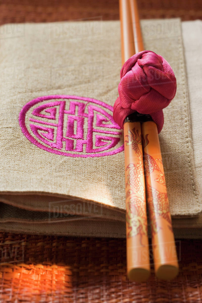 Chopsticks on fabric napkin (Asia) Stock Photo Dissolve