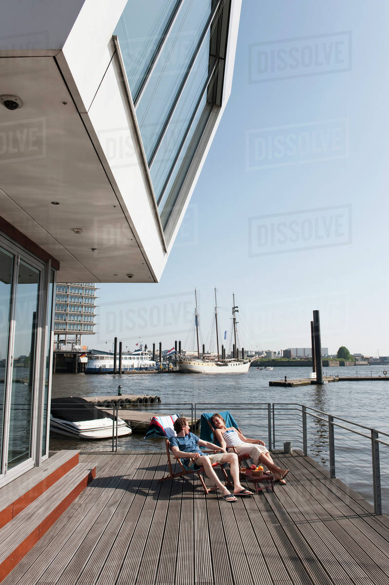 Germany Hamburg Relaxing In Deck Chair On Floating Home Germany Hamburg Relaxing In Deck Chair On Floating Home
