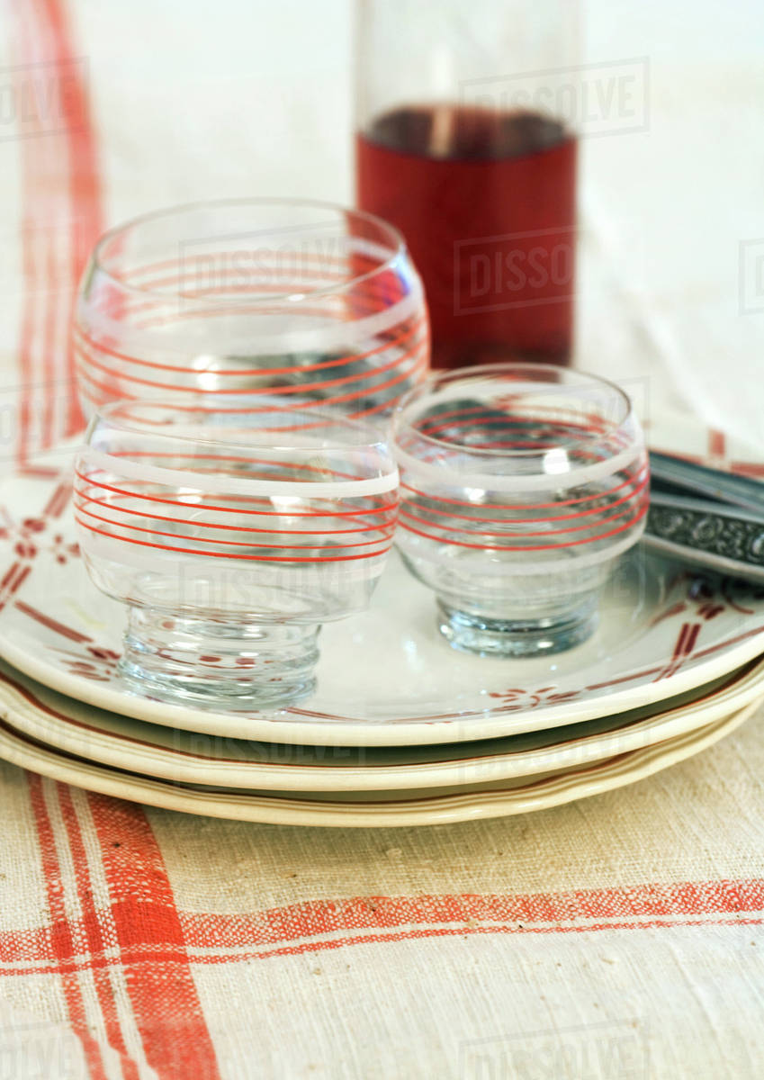 Stack of clean plates, glasses and silverware Stock Photo Dissolve