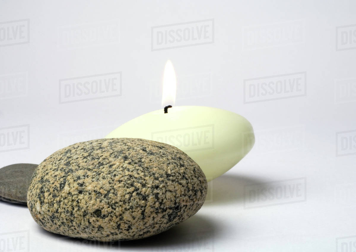 Stones and candle Stock Photo Dissolve