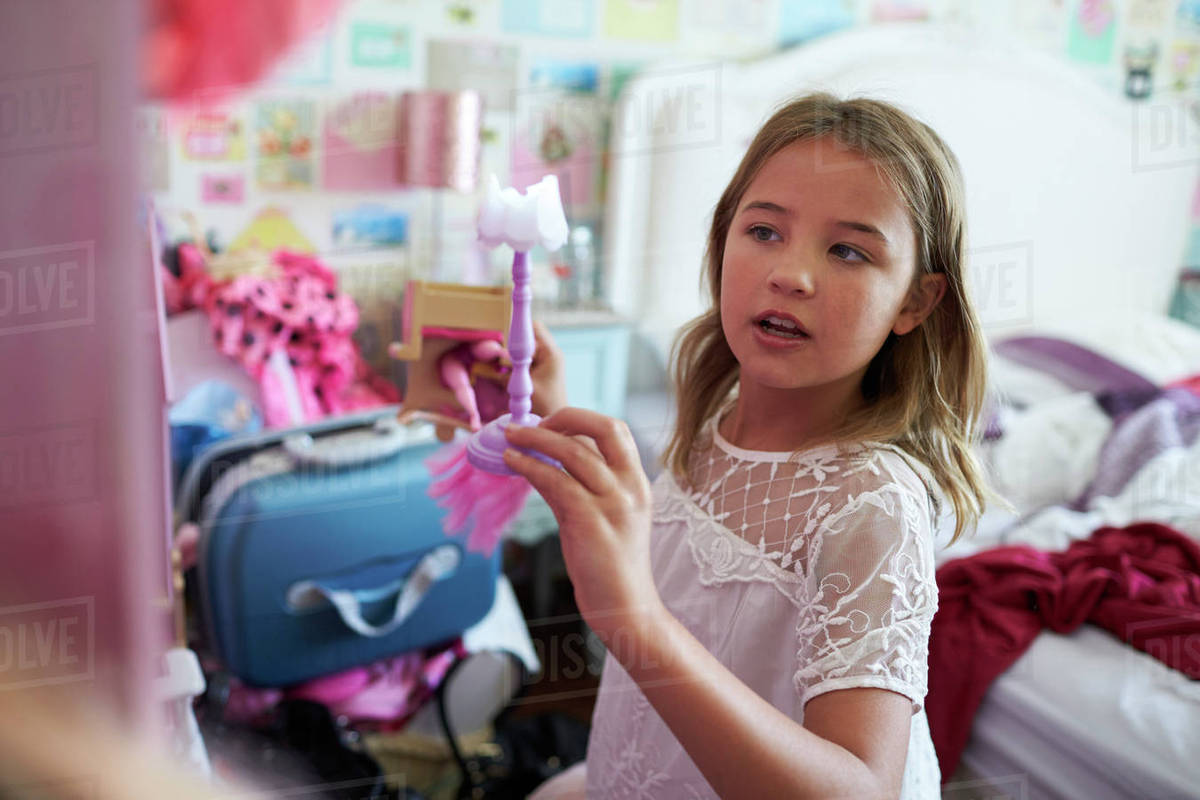 girl playing with dolls