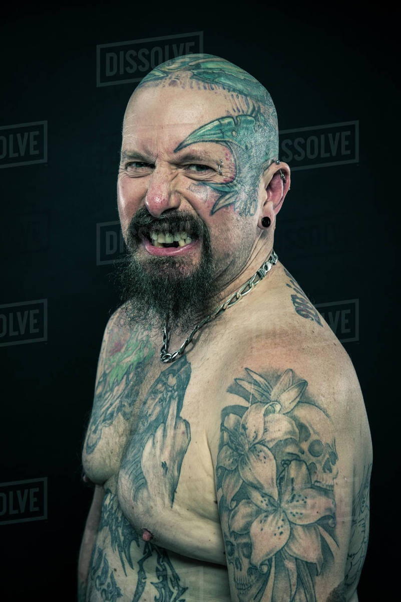Studio portrait of a heavily tattooed older man Stock Photo Dissolve