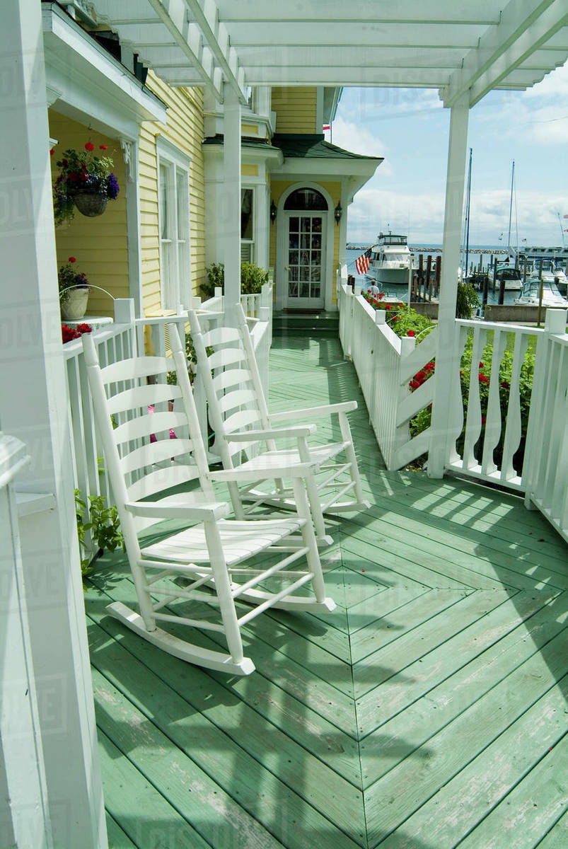 Rocking chairs on a verandah, USA. Stock Photo Dissolve