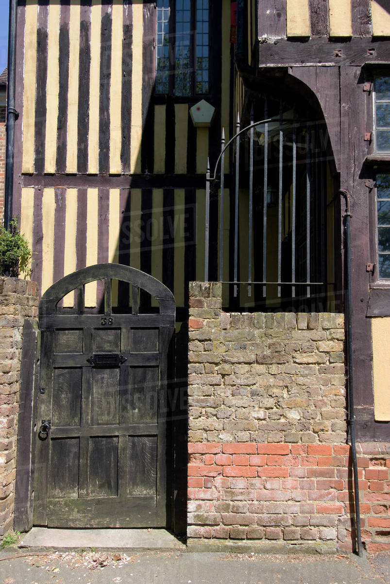 Timber framed building with gate and brick wall in Tudorstyle house