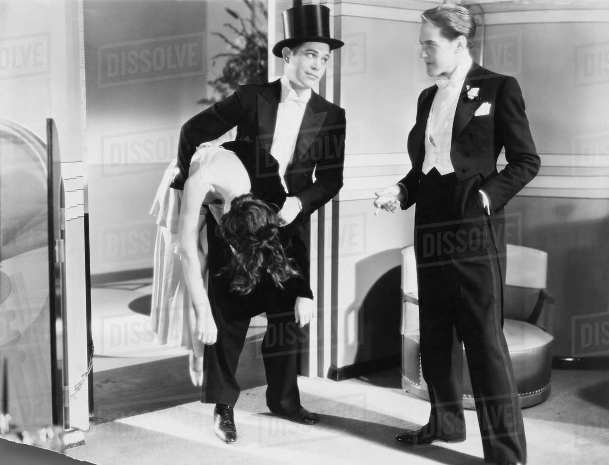 Two men in tuxedos with unconscious woman Stock Photo Dissolve