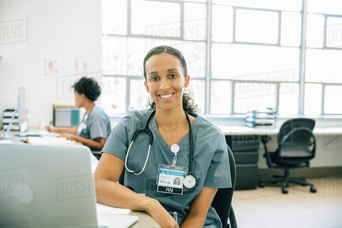 Portrait of smiling nurse with laptop Royalty-free stock photo