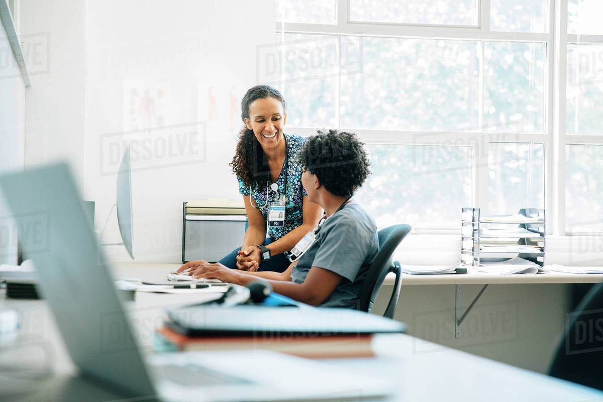 Nurses laughing at computer in office Royalty-free stock photo