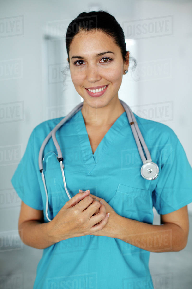 Smiling Hispanic nurse in scrubs Stock Photo Dissolve