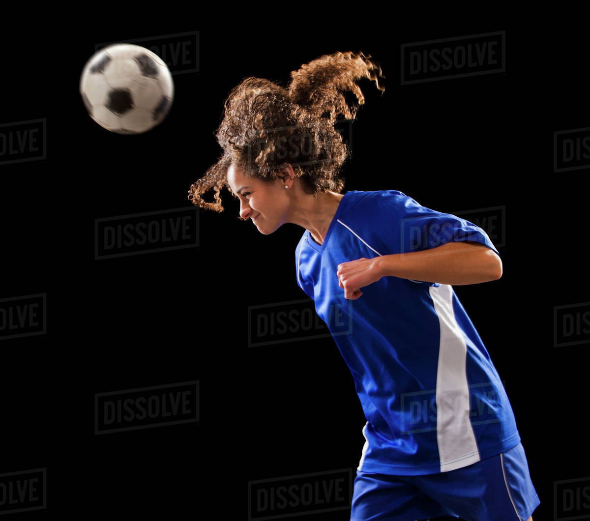 Caucasian soccer player heading the ball Stock Photo Dissolve