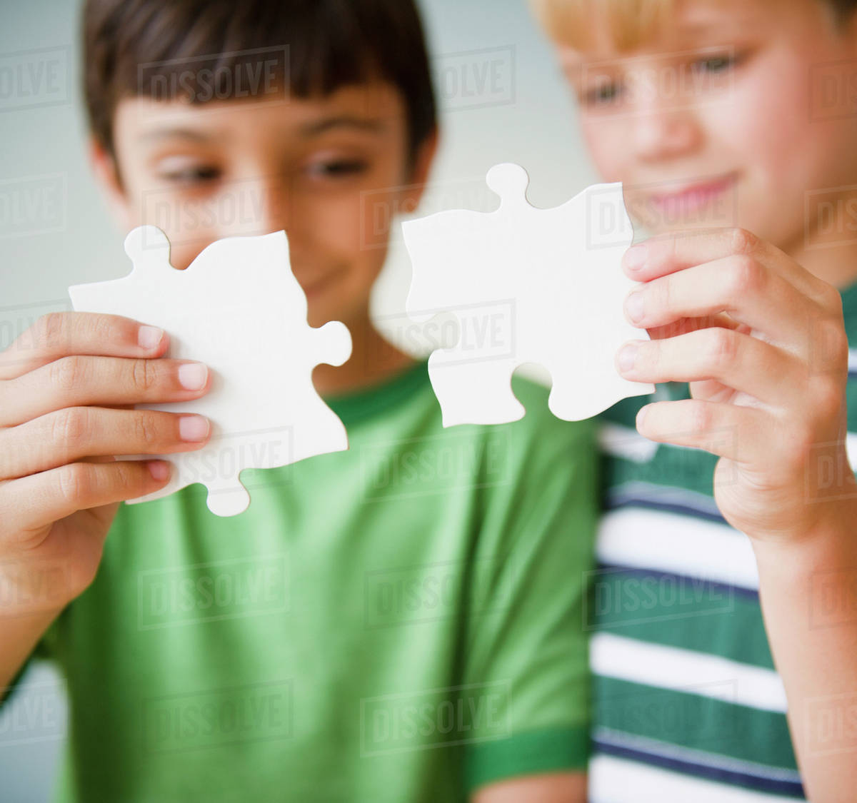 Boys putting jigsaw puzzle together Stock Photo Dissolve