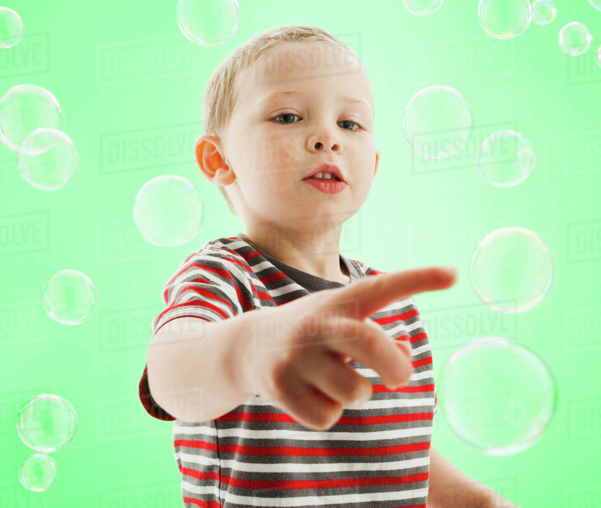 Caucasian boy popping bubbles Stock Photo Dissolve