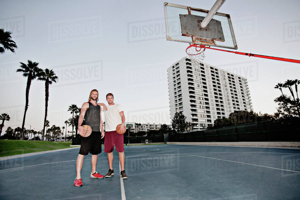 Caucasian men standing on basketball court - Royalty-free Stock Photo ...