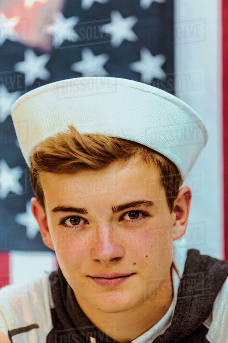 Caucasian teenage boy wearing sailor hat Stock Photo Dissolve
