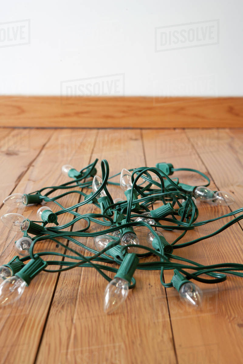 Christmas lights tangled on floor Stock Photo Dissolve
