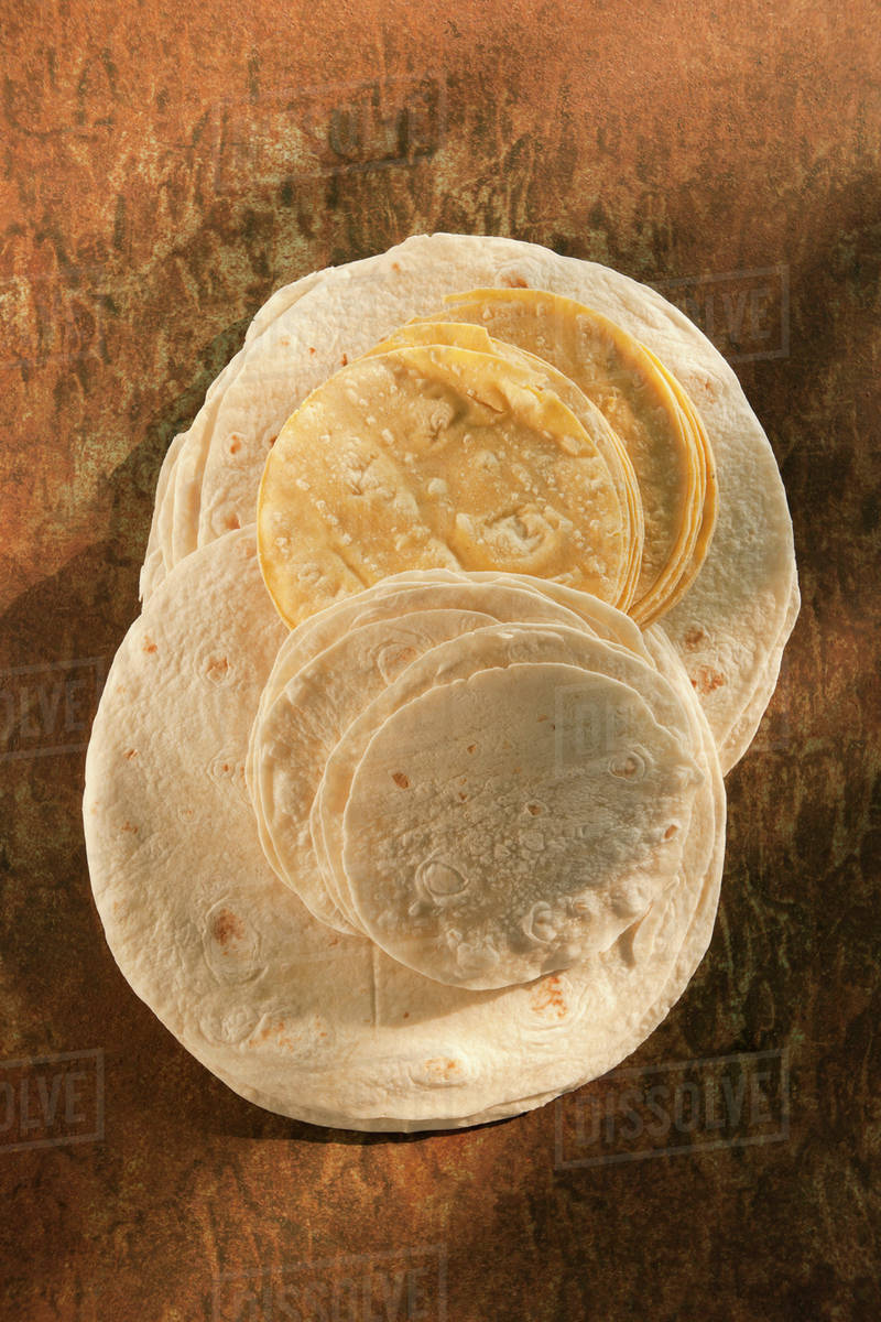 Flour and corn tortillas on table Stock Photo Dissolve