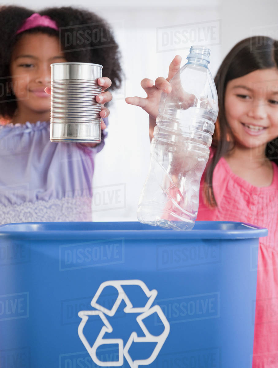 Girls recycling can and bottle Stock Photo Dissolve