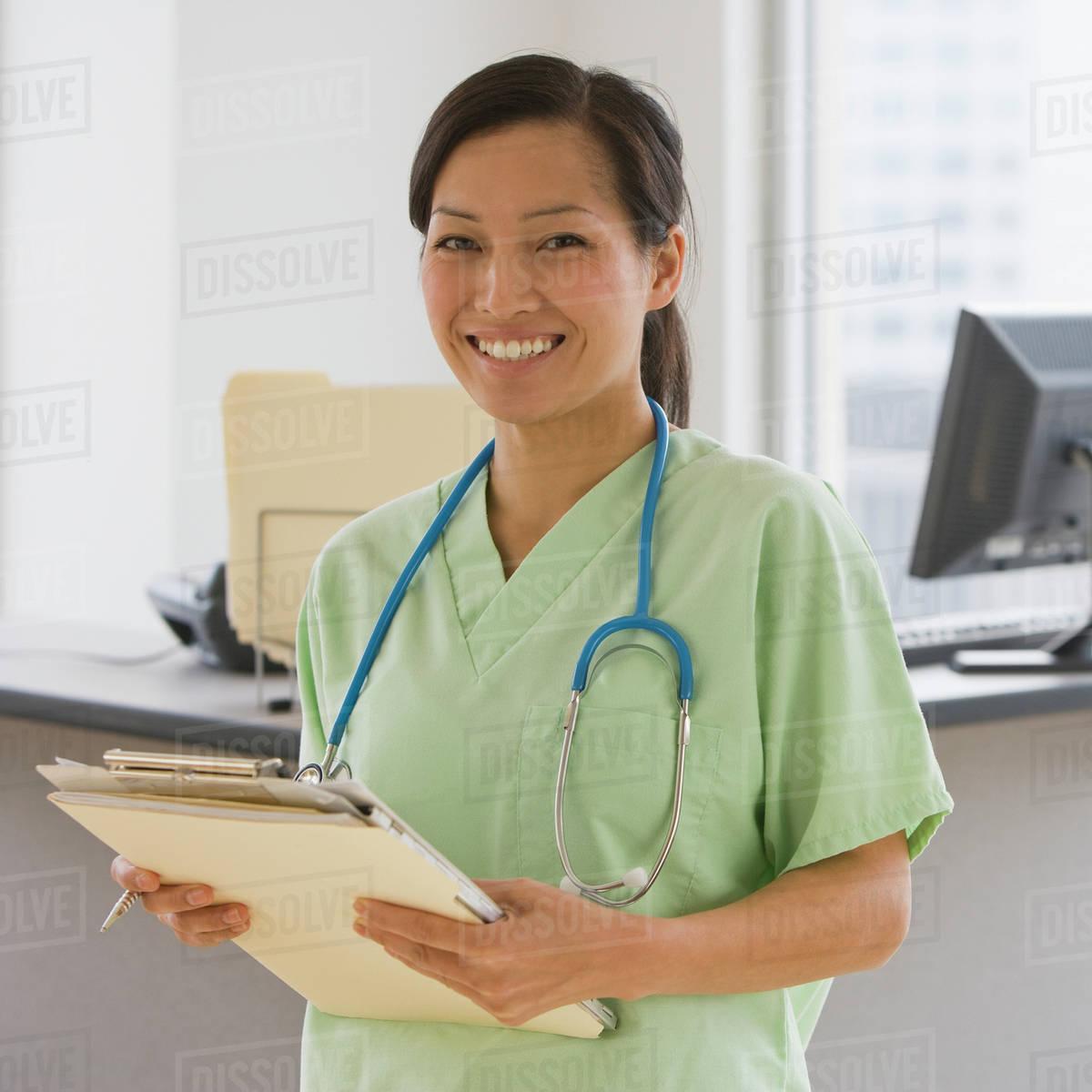 Asian Female Doctor Holding Chart Stock Photo Dissolve