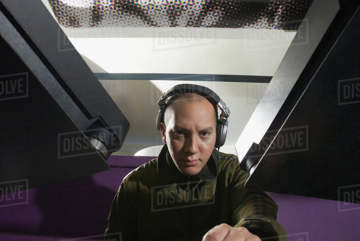 Hispanic DJ wearing headphones Stock Photo Dissolve