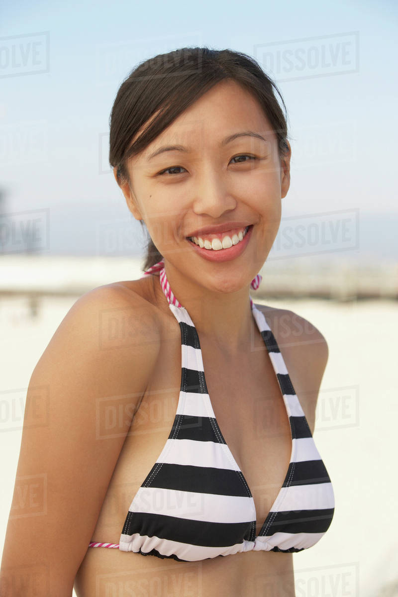 Smiling Asian woman wearing bikini at beach Royalty-free stock photo