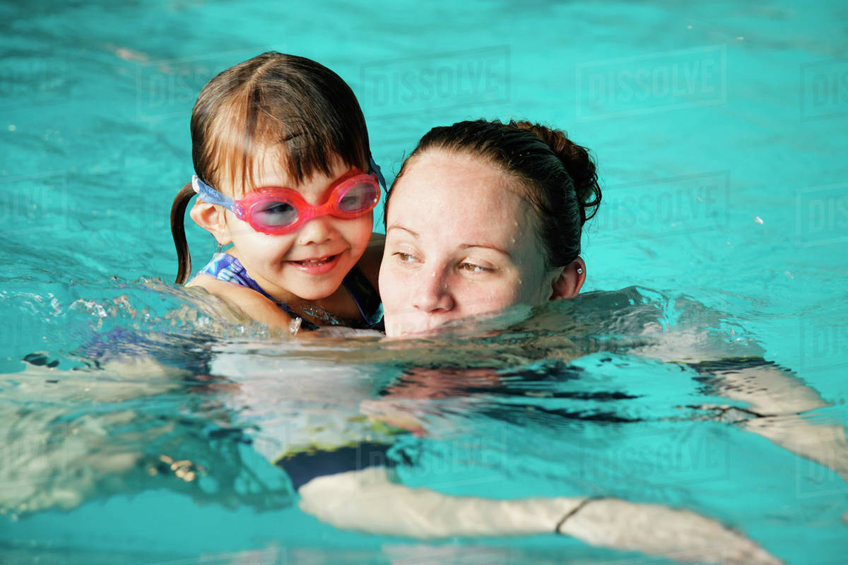 Mother and young daughter swimming - Stock Photo - Dissolve