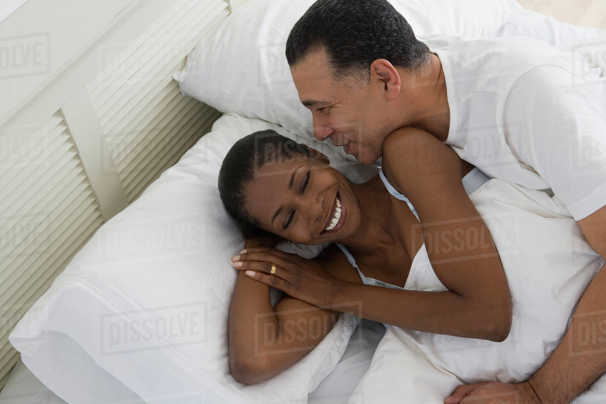 Middle Aged African Hugging In Bed Stock Photo Dissolve Middle Aged African Hugging In Bed