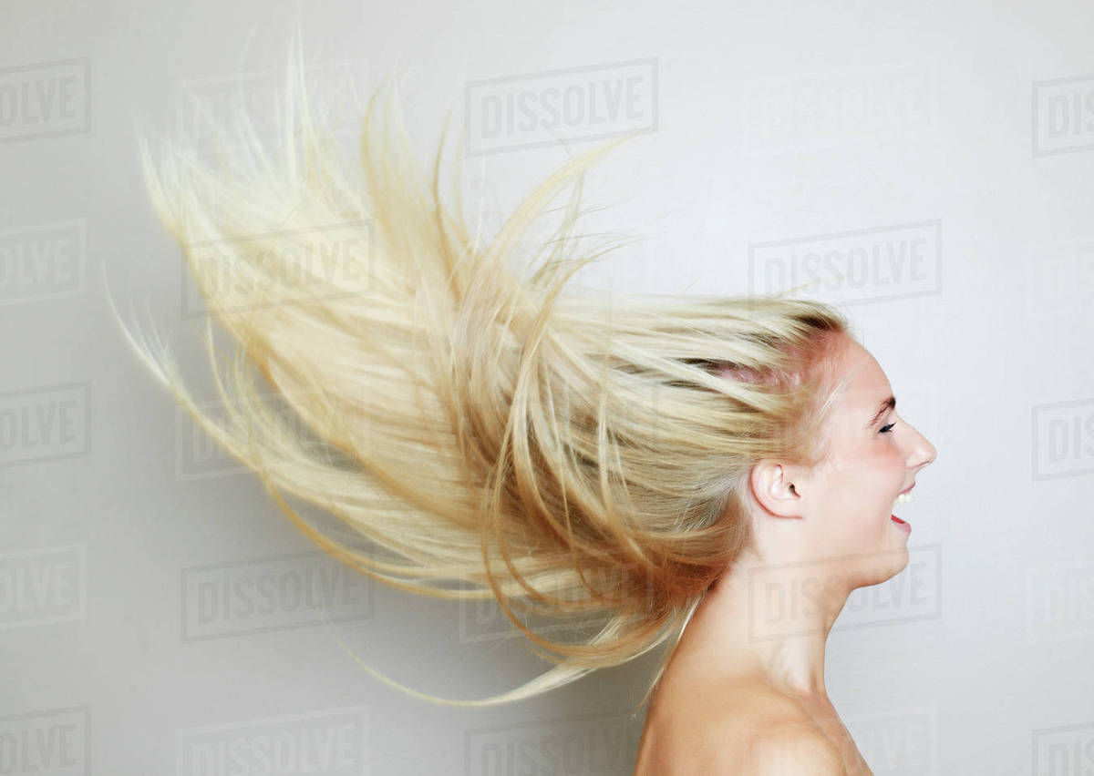Blonde hair of Caucasian woman blowing in wind Stock Photo Dissolve