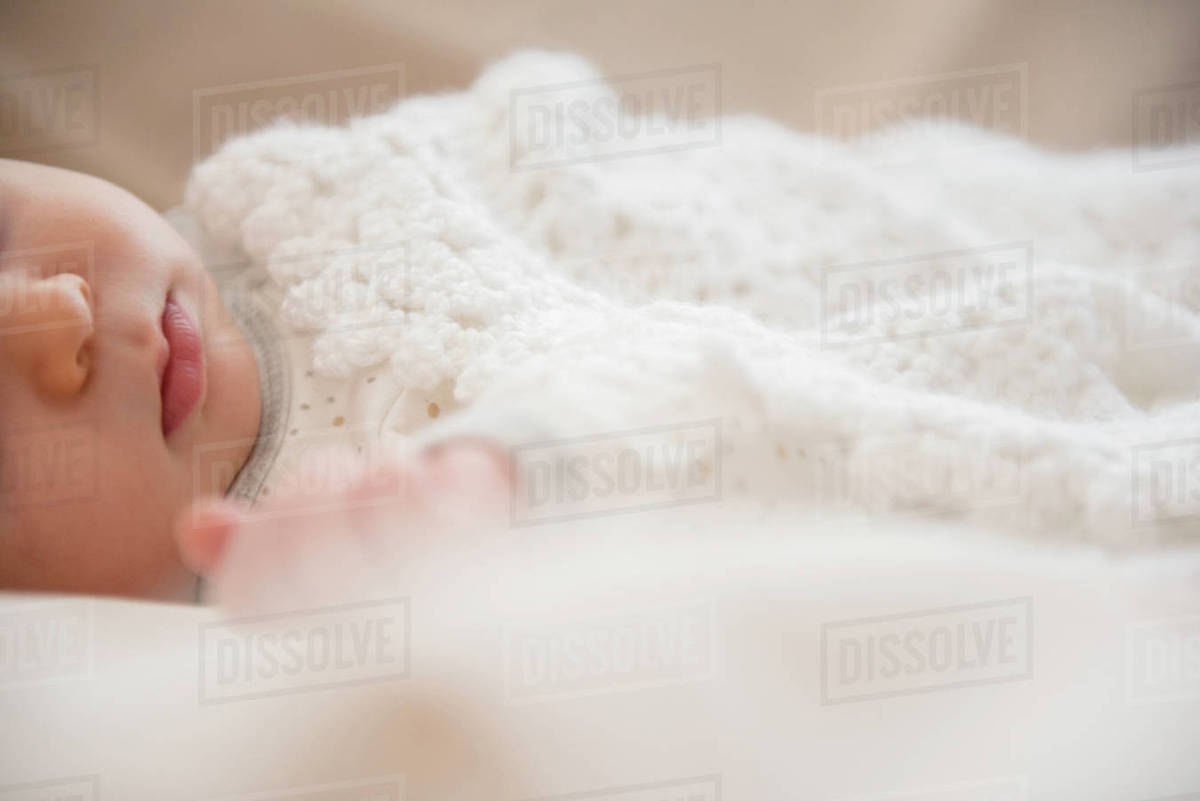 Caucasian baby wrapped in blanket Stock Photo Dissolve
