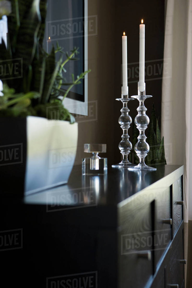 Contemporary dresser with candlesticks and house plant Stock Photo