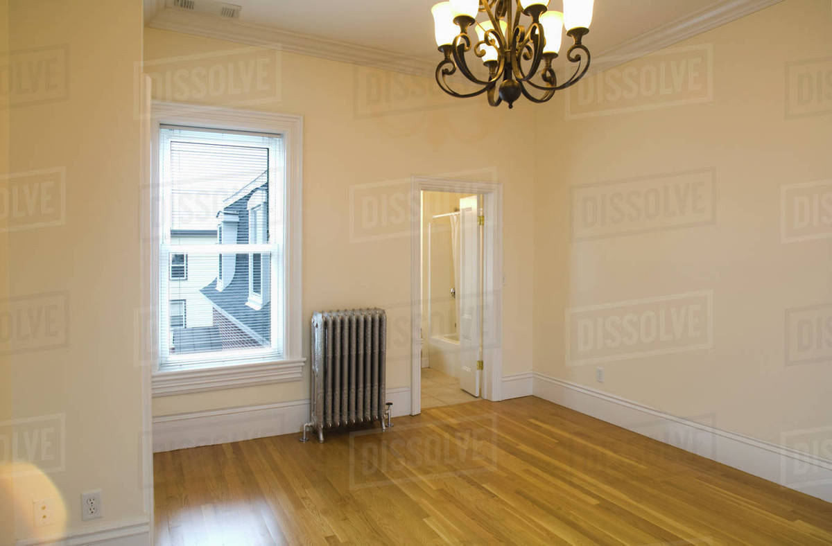 Empty Room In Apartment With Hardwood Floor And Heater Stock Photo Empty Room In Apartment With Hardwood Floor And Heater