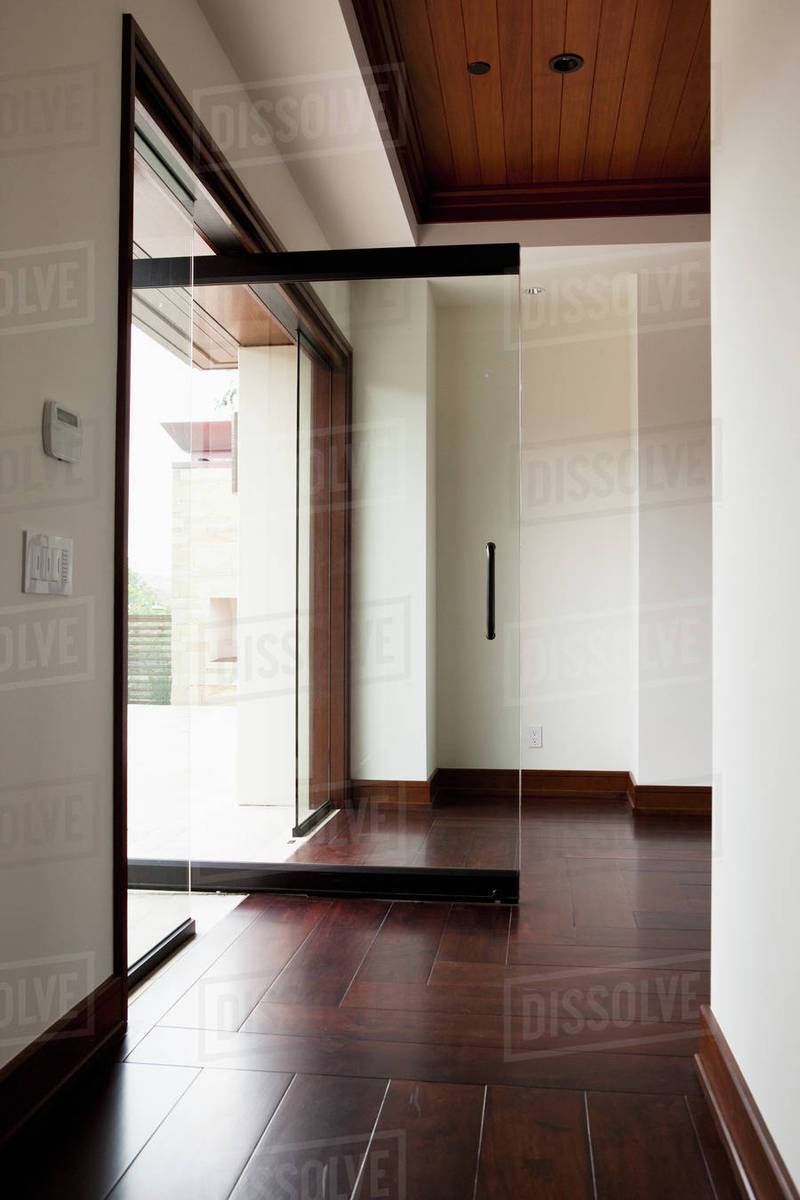 Hallway With Wooden Floor And Open Glass Door Stock Photo