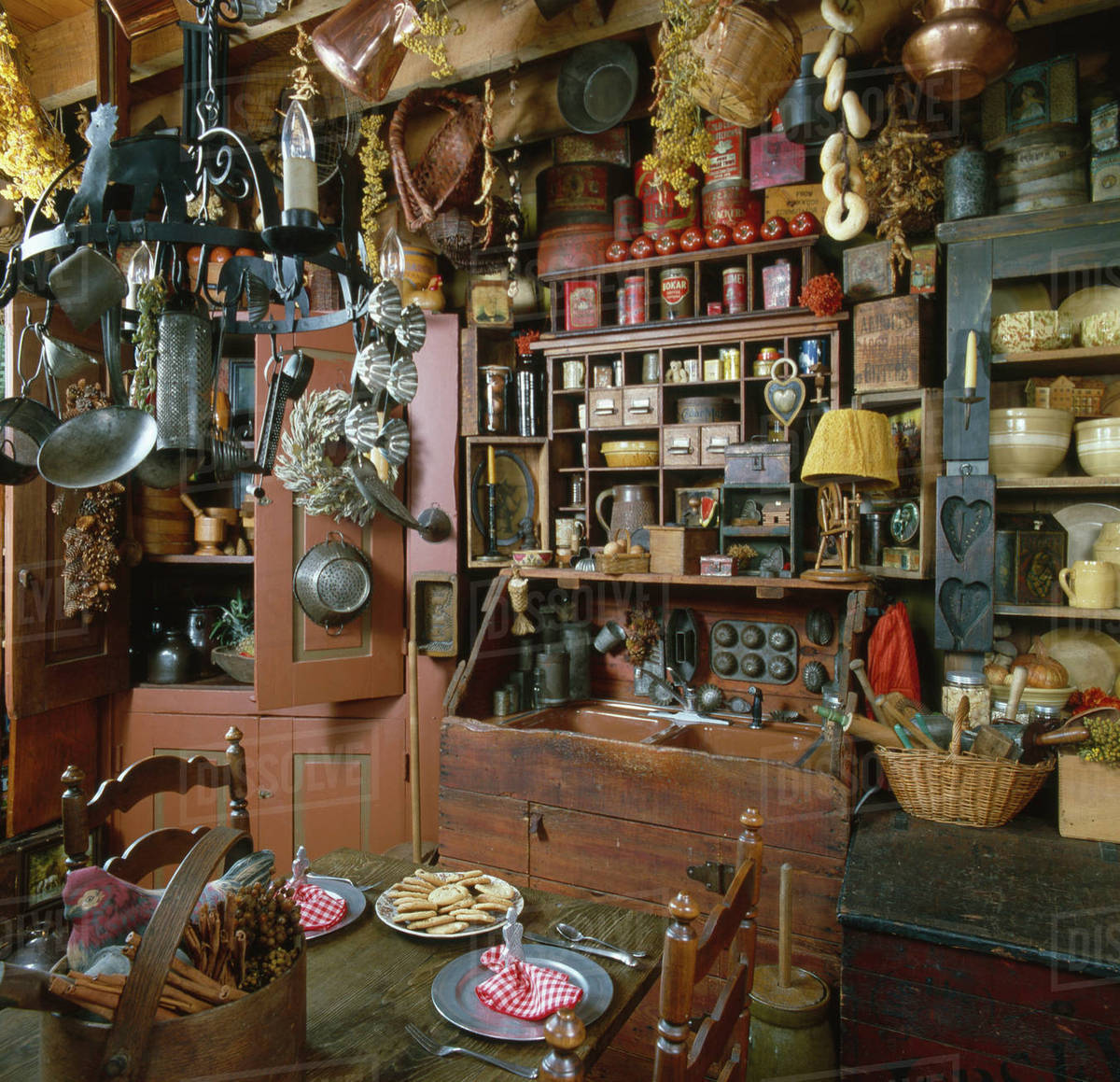 Interior of a country kitchen with old utensils hanging from ceiling