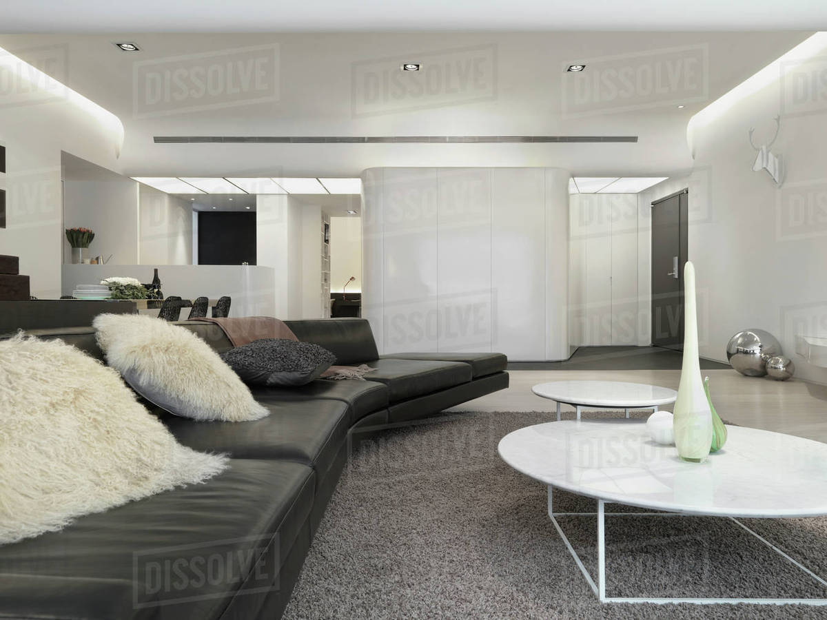 View Down Modern Leather Sofa With Fur Pillows Stock Photo