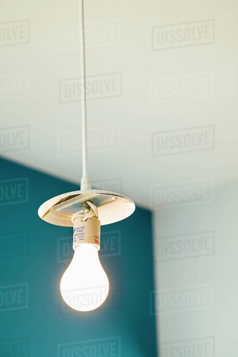 Light Bulb Hanging From White Cord Stock Photo Dissolve