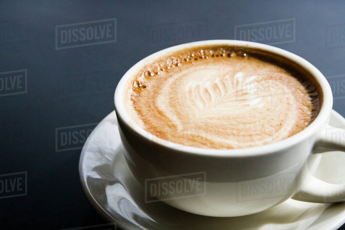 Leaf design in espresso foam Stock Photo Dissolve