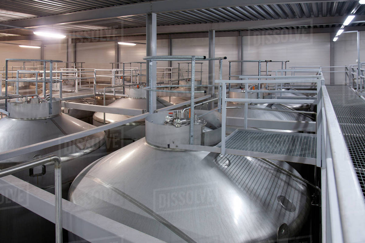 Stainless steel vats in factory Stock Photo Dissolve