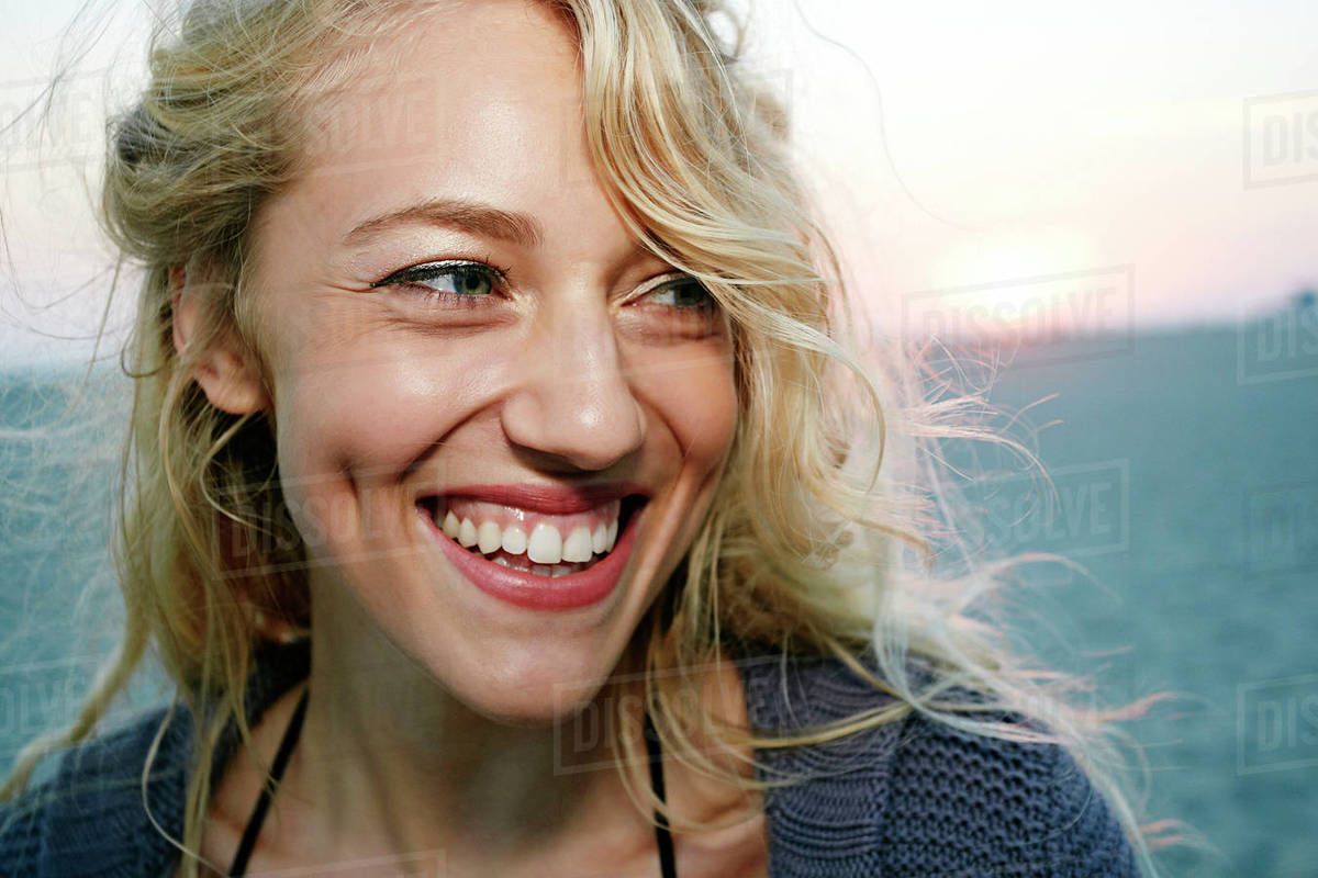 Woman smiling on beach - Stock Photo - Dissolve