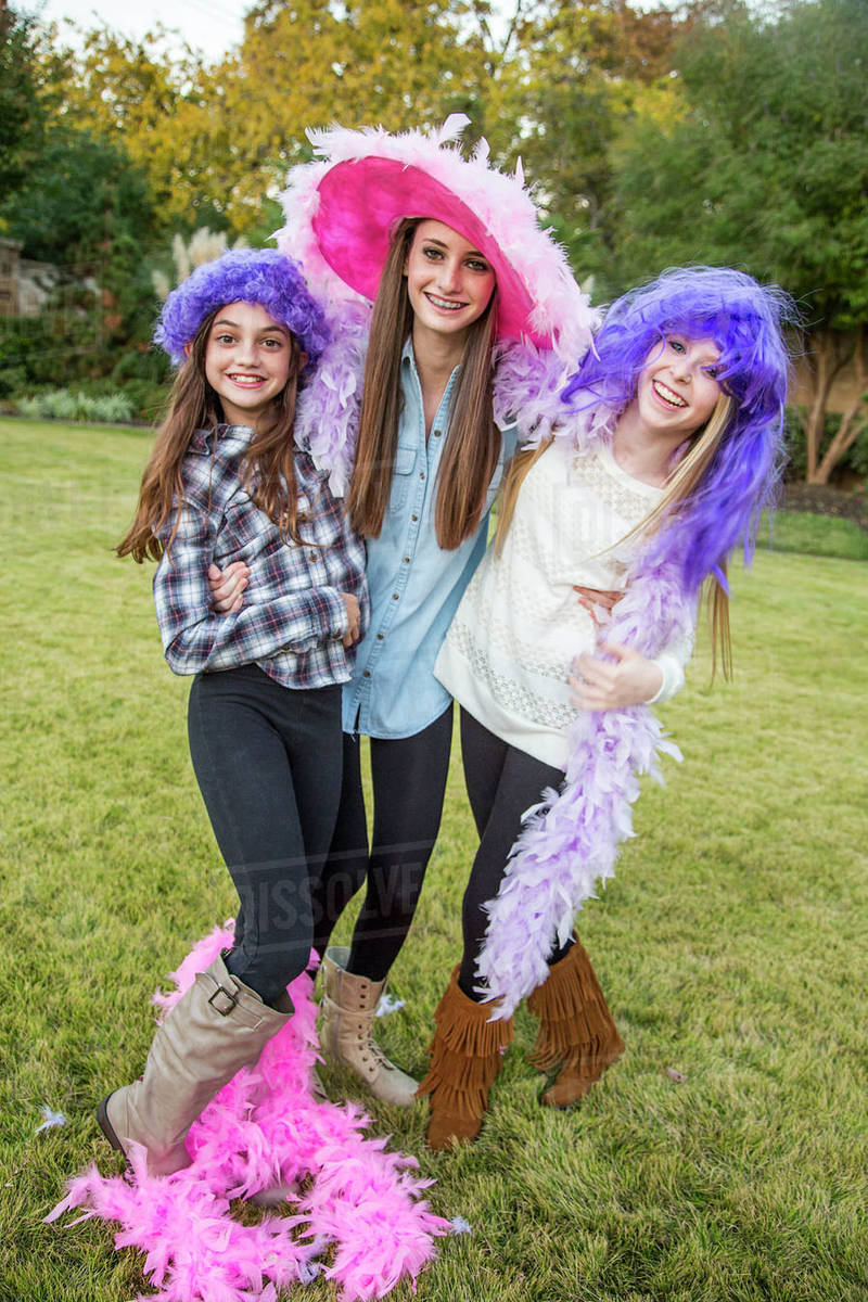 Caucasian teenage girls wearing feather boas and costumes Stock Photo Dissolve