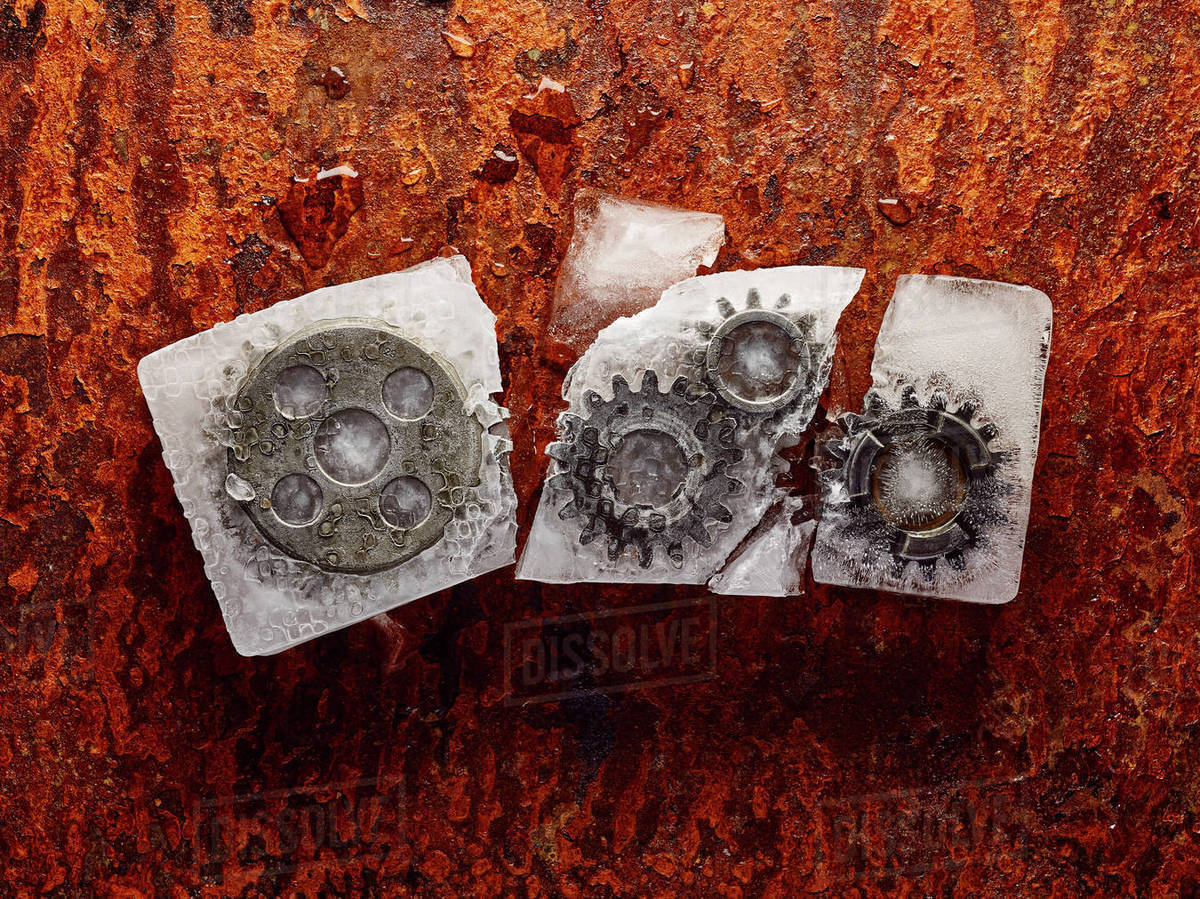 Gears frozen in broken ice Stock Photo Dissolve