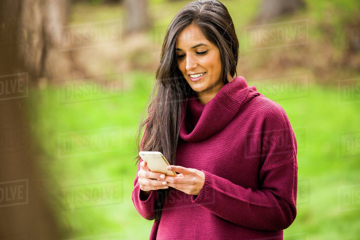 Smiling Indian Woman Texting On Cell Phone Stock Photo Dissolve