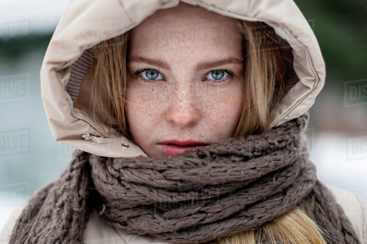 Caucasian woman wearing hood and scarf Stock Photo Dissolve