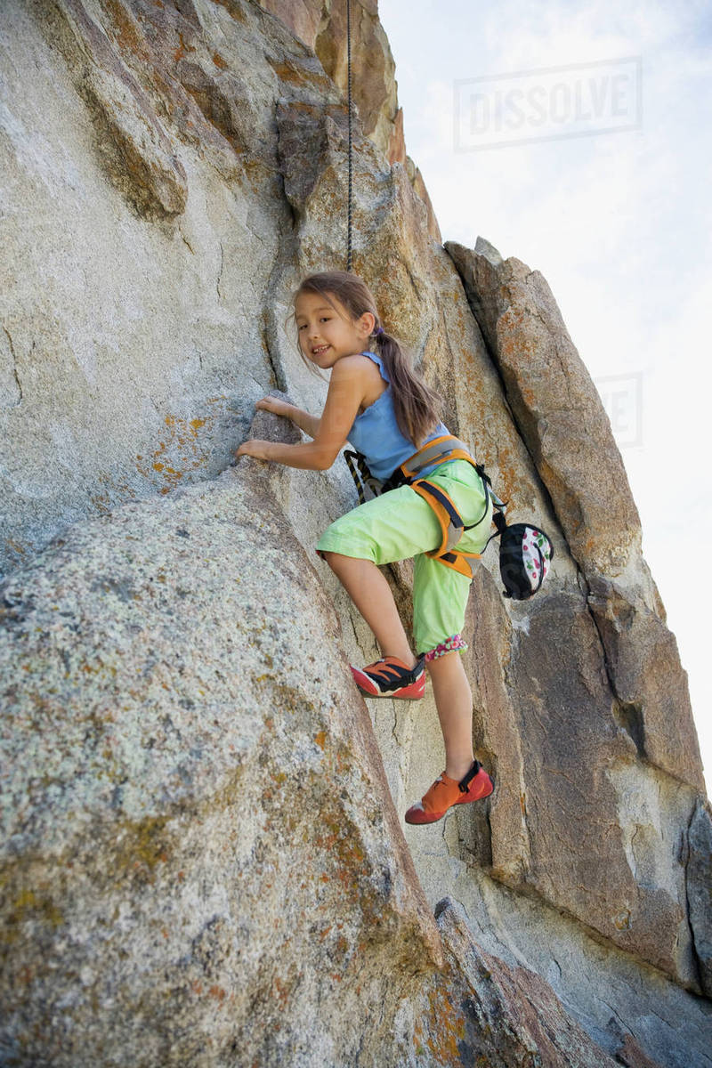 Asian girl rock climbing Stock Photo Dissolve