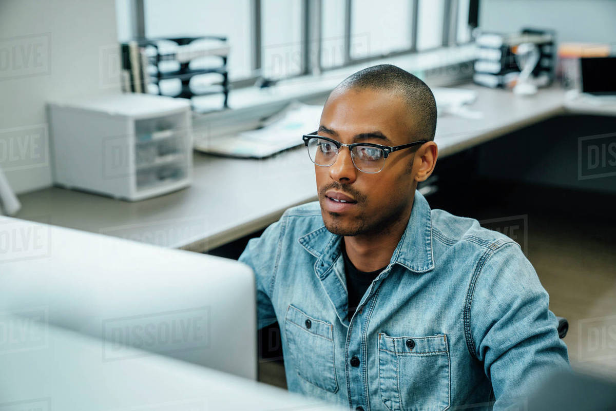 Black businessman using computer Stock Photo Dissolve