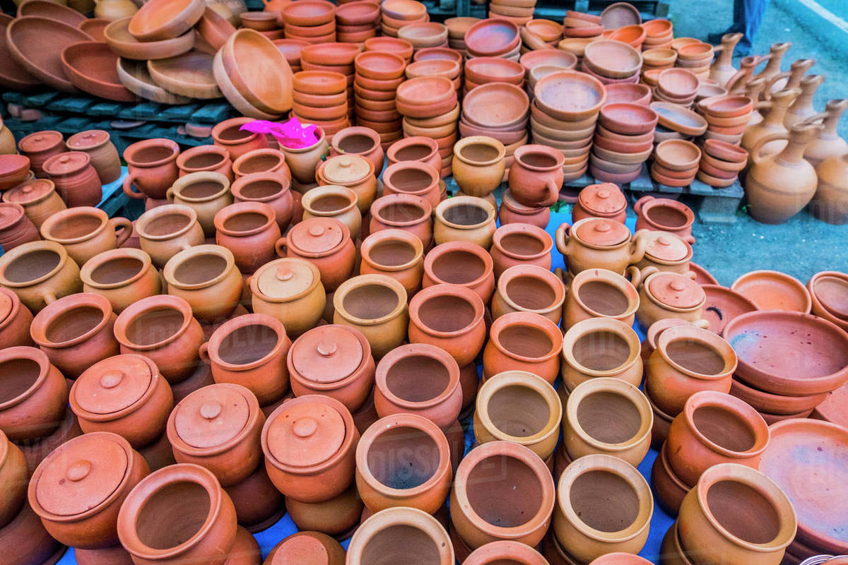Clay pots and bowls on floor Stock Photo Dissolve