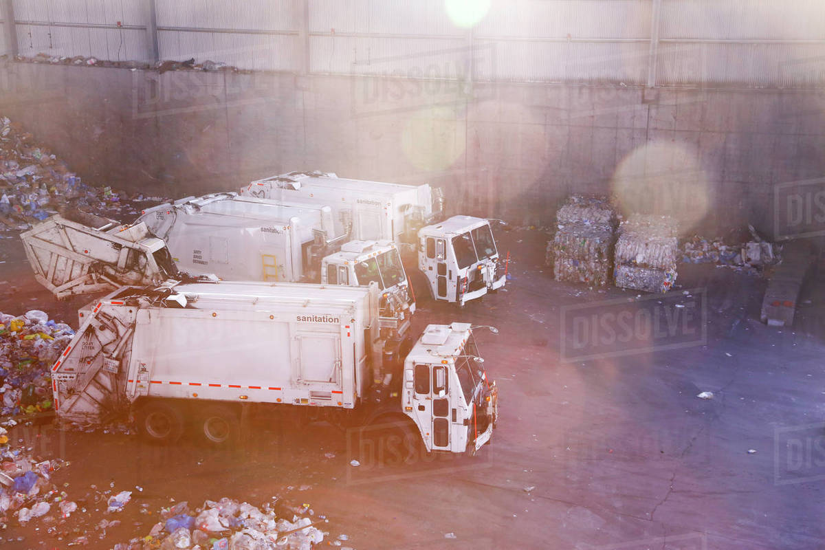 Garbage trucks unloading trash Stock Photo Dissolve
