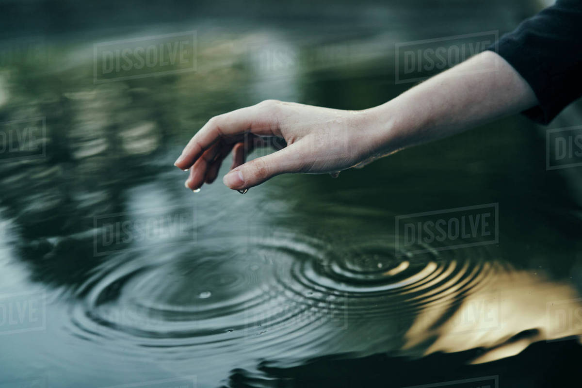 Water dripping from hand of woman Stock Photo Dissolve