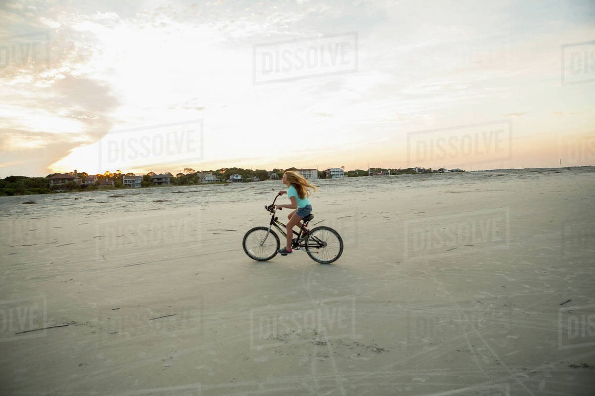 Caucasian Riding Bicycle On Beach Stock Photo Dissolve Caucasian Riding Bicycle On Beach