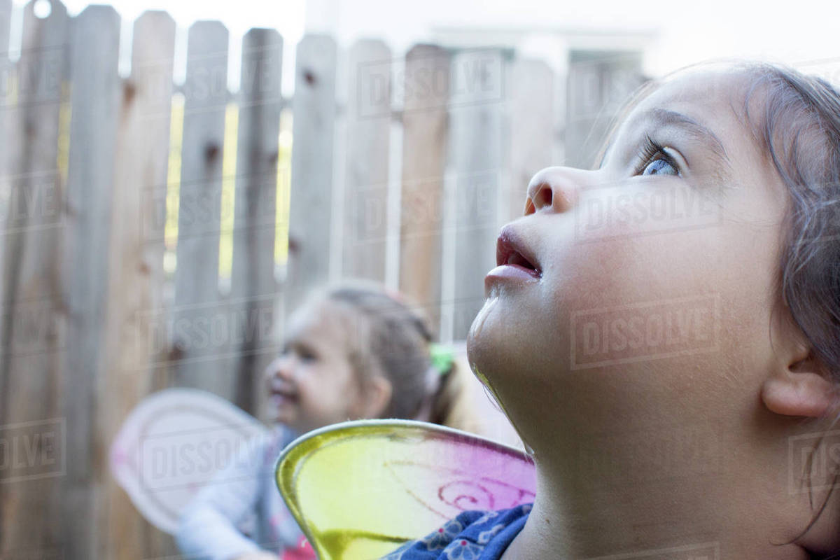 Curious girls wearing fairy wings outdoors Royalty-free stock photo