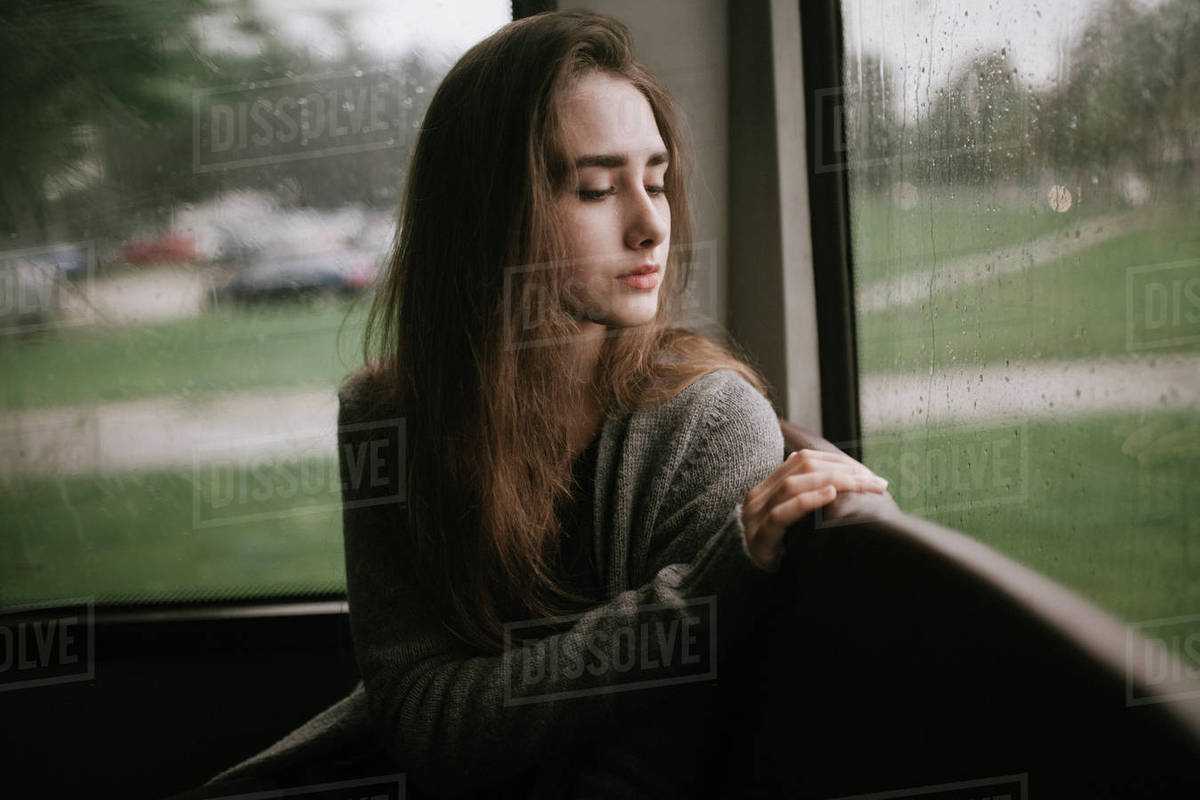 Pensive Caucasian Woman Sitting On Bus In Rain Stock Photo Dissolve