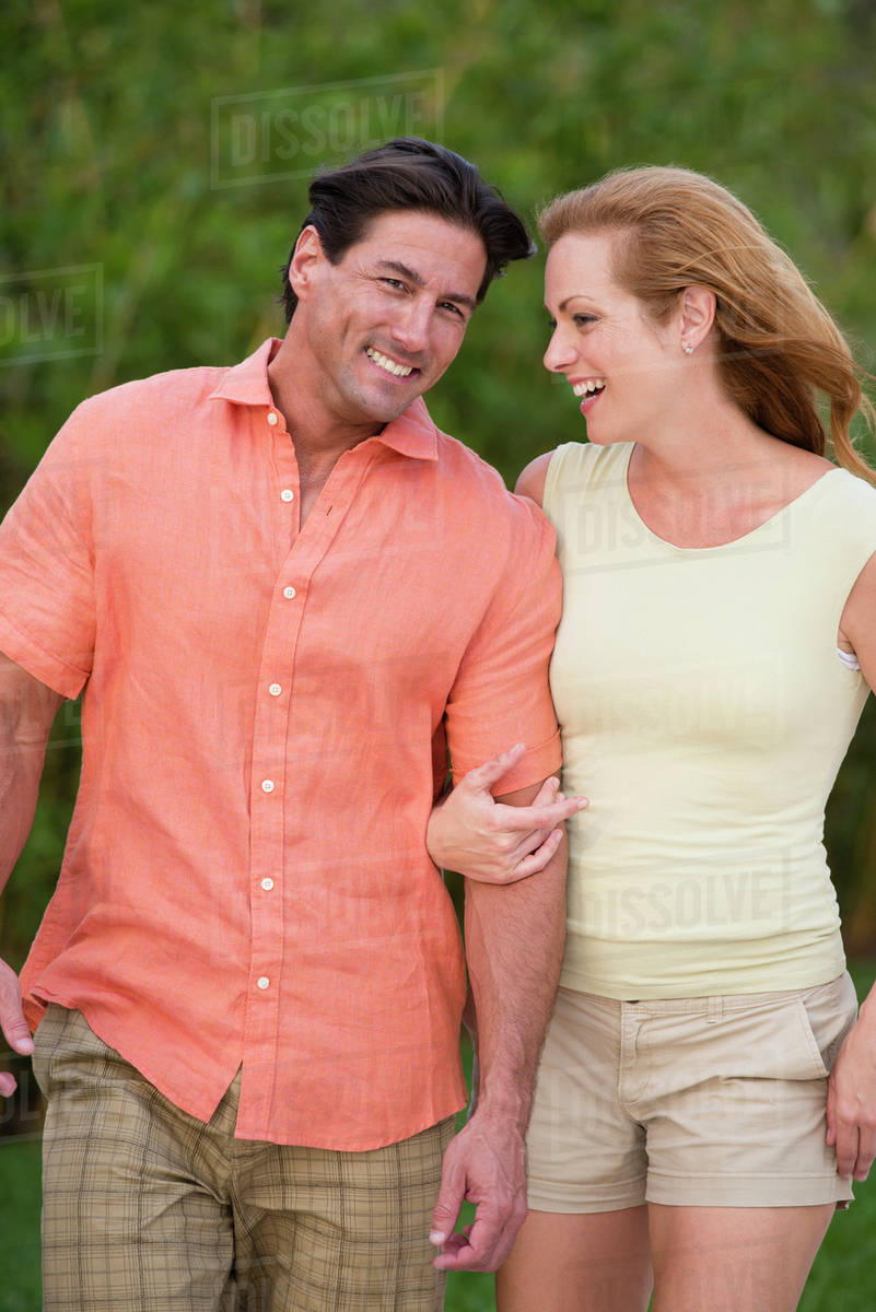 Caucasian couple walking together outdoors Stock Photo Dissolve