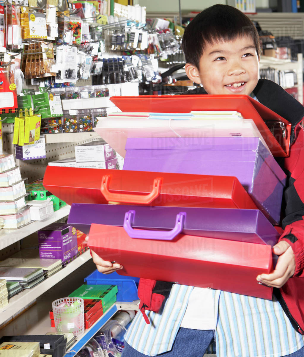 Chinese boy buying school supplies in store Stock Photo Dissolve
